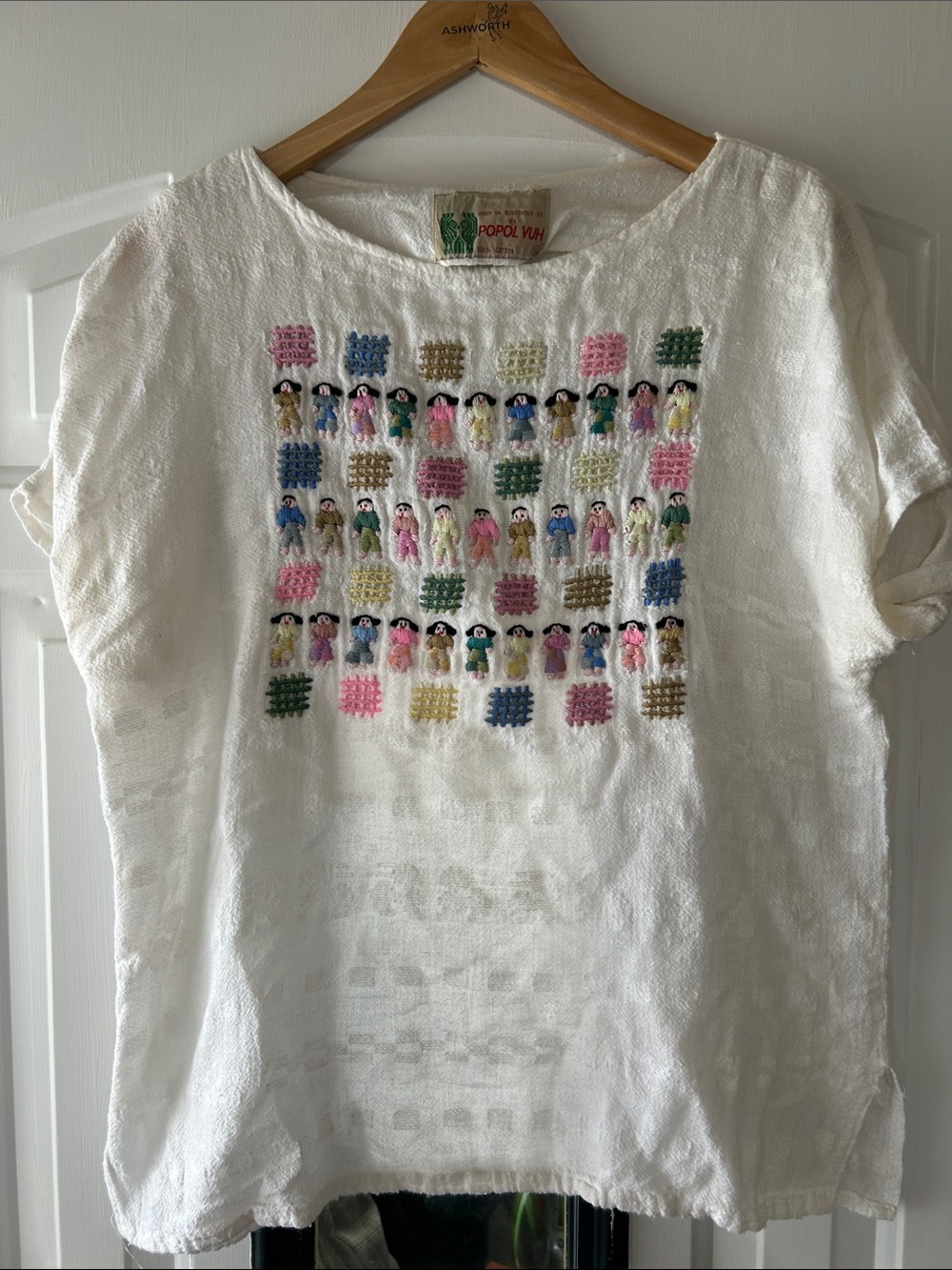Hand-Embroidered White Cotton Blouse with Multicolor Doll Motif